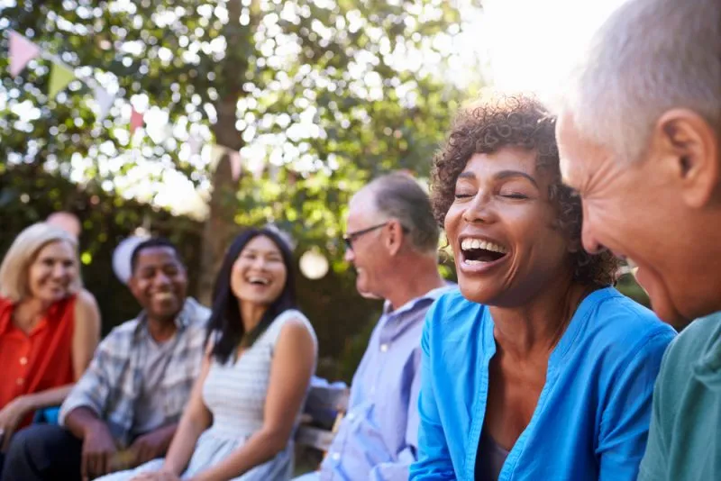 group of friends sitting outside laughing